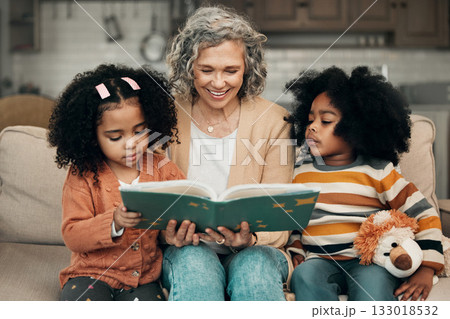 Family kids, book and grandma reading fantasy storybook, story or bonding on home living room sofa. Grandmother love, novel and elderly woman with child development for biracial kindergarten children 133018532