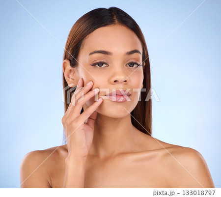Skincare, makeup and portrait woman beauty with smooth clear skin after cosmetic treatment or facial isolated in a studio blue background. Soft, natural and clean serious model due to dermatology 133018797