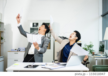Two excited businessmen cheering with joy in office after success. Concept of teamwork, business win 133018947