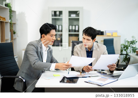 Frustrated manager scolds employee in office over financial error. Concept of workplace stress, reporting issues, conflict Frustrated manager scolds employee in office over financial error. Concept of workplace stress, reporting issues, conflict 133018955