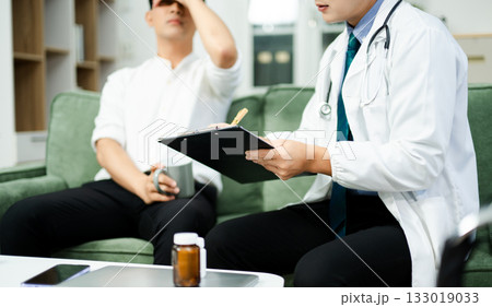 Doctor giving emotional support and medication advice to stressed male patient. Mental health, therapy, and care 133019033