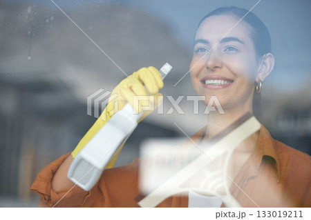 Window cleaning, woman smile and happy maid at home washing windows with glass cleaner. Helping, working and girl with spray for squeegee and house chores and disinfectant doing housekeeping 133019211