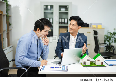 Professional team collaboration in modern office, discussing real estate model and signing contract, concept of startup Professional team collaboration in modern office, discussing real estate model and signing contract, concept of startup 133019310