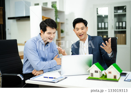 Professional team collaboration in modern office, discussing real estate model and signing contract, concept of startup Professional team collaboration in modern office, discussing real estate model and signing contract, concept of startup 133019313