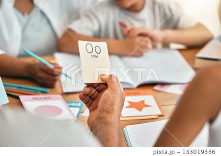 Learning, cards and parents with children and alphabet lesson for language, study and letter. School, homework and help with family at table and teaching for reading tutor, literacy and phonics 133019386