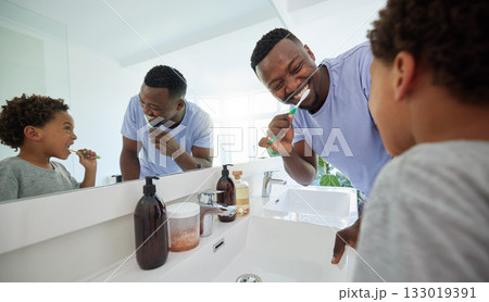 Smile, brushing teeth and father with son in bathroom for dental, morning routine and cleaning. Teaching, self care and toothbrush with black man and child at home for family wellness and hygiene Smile, brushing teeth and father with son in bathroom for dental, morning routine and cleaning. Teaching, self care and toothbrush with black man and child at home for family wellness and hygiene 133019391