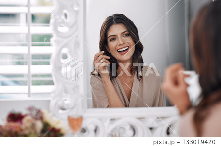 Beauty results, mirror and happy woman check cosmetics application, natural skincare glow or luxury facial makeup. Spa salon, skin health and relax person smile for face treatment in house bedroom 133019420