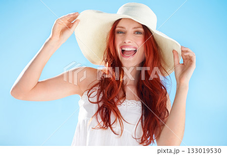 Happy woman, excited portrait and straw hat outdoor on blue sky, fun style and freedom to relax. Female person, red hair and smile in sunshine with fashion accessory, happiness and summer holiday 133019530
