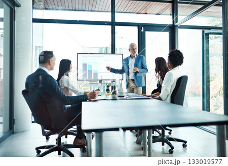 Corporate training, team and man with presentation, leader or graph for financial growth, budget or charts. Male person, employee or accountant with group, staff or coworkers in a meeting and talking 133019577