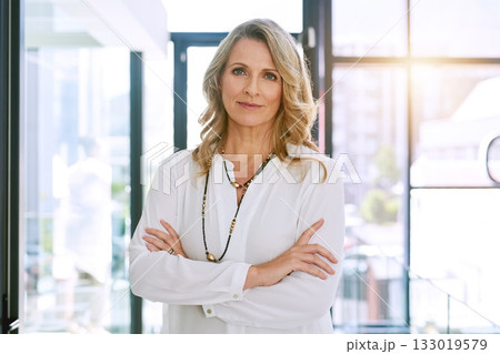 Crossed arms, office and portrait of business woman with confidence, empowerment and career pride. Corporate, management and face of senior female worker with future vision, mission and motivation 133019579