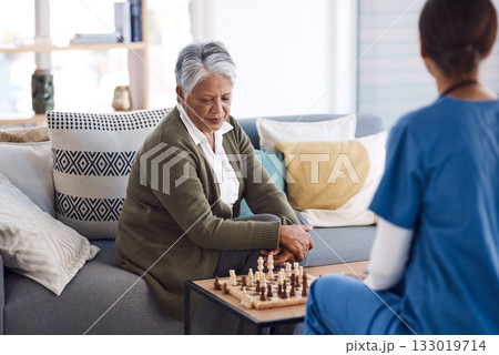 Nurse, chess or old woman in nursing home for healthcare, problem solving skills or mental health recovery. Relaxing, caregiver or focused mature patient thinking of solution or playing board games 133019714