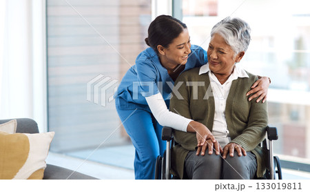 Hug, nurse with senior woman in wheelchair and talking for support. Happy, smile and communication with female nurse holding disabled senior patients hand for caregiver in nursing home consulting Hug, nurse with senior woman in wheelchair and talking for support. Happy, smile and communication with female nurse holding disabled senior patients hand for caregiver in nursing home consulting 133019811