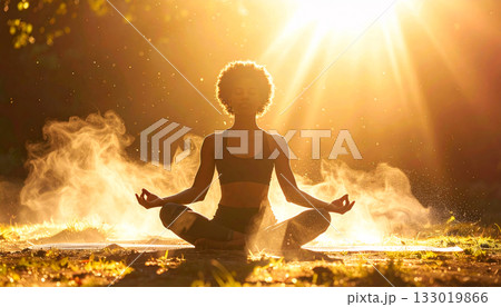 Sunbeam illuminates yoga pose and floating dust, Symbol of person spiritual awakening 133019866