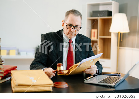 Male judge in courtroom, lawyer working in office. Perfect for business, legal advice, corporate law, and professional consulting themes. Male judge in courtroom, lawyer working in office. Perfect for business, legal advice, corporate law, and professional consulting themes. 133020055