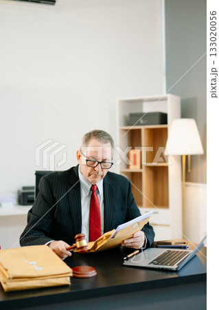 Professional male lawyers consulting on legal cases in a modern office. Perfect for law, business, justice, legal advice Professional male lawyers consulting on legal cases in a modern office. Perfect for law, business, justice, legal advice 133020056