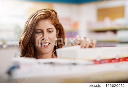 Happy woman, shopping and pharmacy on shelf for drugs, pills or medication for healthcare at store. Female person, customer or patient checking pharmaceutical products, medicine or stock at a clinic 133020082