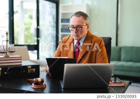 Man lawyer working and gavel, tablet, laptop in front, Advice justice and law concept. 133020093