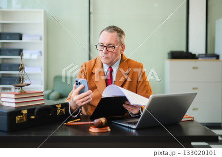 Man lawyer working and gavel, tablet, laptop in front, Advice justice and law concept. Man lawyer working and gavel, tablet, laptop in front, Advice justice and law concept. 133020101