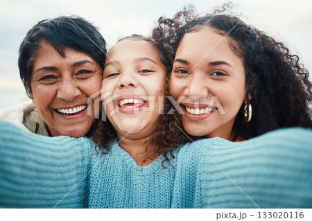 Happy family, portrait and selfie by girl with mother and grandmother outdoors together. Travel, face and picture with females on vacation in Bali, relax and bonding, carefree and embracing for photo Happy family, portrait and selfie by girl with mother and grandmother outdoors together. Travel, face and picture with females on vacation in Bali, relax and bonding, carefree and embracing for photo 133020116