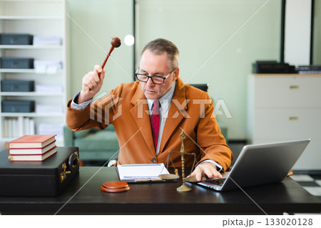 Mature Male judge in a courtroom on white table and Counselor or Male lawyer working in office. Justice and law concept 133020128