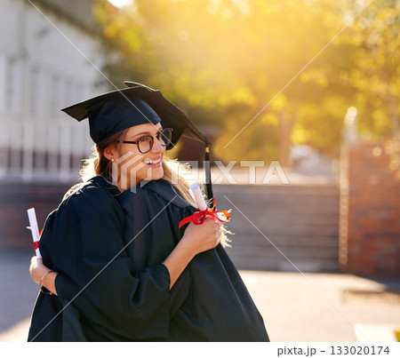 Women, students and hug at graduation as college or university friends with achievement. Happy people outdoor to celebrate education goals, certificate of success or future at school event with pride Women, students and hug at graduation as college or university friends with achievement. Happy people outdoor to celebrate education goals, certificate of success or future at school event with pride 133020174