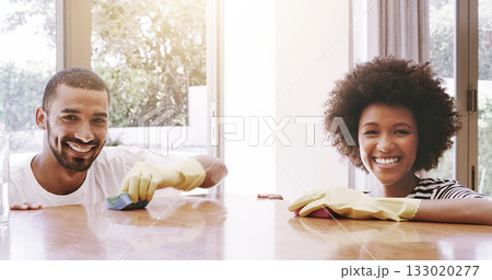 Happy couple, portrait and home for cleaning furniture, table and housekeeping maintenance. Face of man, woman and smile together to wipe surface for dust, bacteria and responsibility of disinfection 133020277