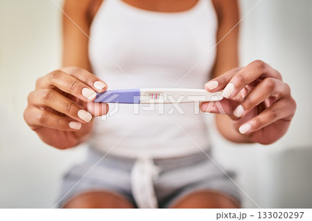 Hands, woman and closeup of a positive pregnancy test by a woman in the bathroom of her home. Maternity, motherhood and zoom of a female person with a pregnant device in her modern house or apartment Hands, woman and closeup of a positive pregnancy test by a woman in the bathroom of her home. Maternity, motherhood and zoom of a female person with a pregnant device in her modern house or apartment 133020297