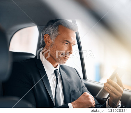 Business man, tablet and car for travel, journey or drive while online for communication. Professional male person with tech and internet connection for work with luxury transportation or a taxi 133020324