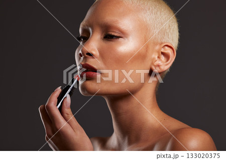 Beauty, makeup and face of woman with lipstick in studio for cosmetics, skincare products and fashion. Salon aesthetic, cosmetology and girl model with red gloss for lips, self love and luxury style 133020375