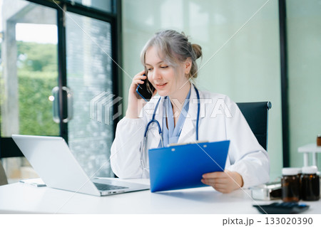 Woman doctor phone call, healthcare talking and medical service writing sick note, surgery planning and prescription.and clinical report test results 133020390