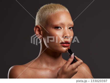 Cosmetics, makeup and portrait of woman with lipstick in studio for beauty, skincare products and fashion. Salon aesthetic, cosmetology and girl model with red gloss for lips, face and luxury style Cosmetics, makeup and portrait of woman with lipstick in studio for beauty, skincare products and fashion. Salon aesthetic, cosmetology and girl model with red gloss for lips, face and luxury style 133020397