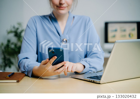 Businesswoman hand working digital marketing media in virtual screen with mobile phone and modern compute with VR icon diagram at office in morning light Businesswoman hand working digital marketing media in virtual screen with mobile phone and modern compute with VR icon diagram at office in morning light 133020432