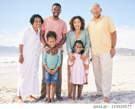 Family at beach, portrait and generations, happy people relax outdoor with grandparents, parents and kids. Happiness, smile and travel, love and care with relationship and bond on vacation in Bali 133020577