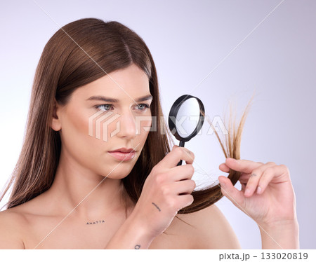 Hair care, beauty split ends and woman with magnifying glass in studio isolated on a background. Cosmetics, female and model face with lens for hairstyle, hairloss and damage after salon treatment. 133020819