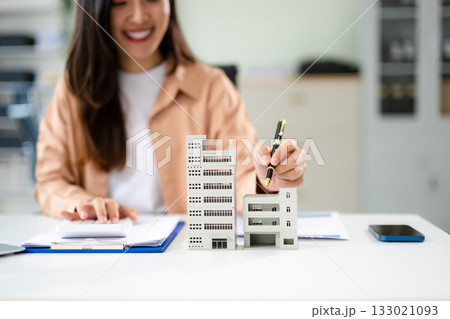 Real estate broker agent presenting and consult to customer to decision making sign insurance form agreement, home model Real estate broker agent presenting and consult to customer to decision making sign insurance form agreement, home model 133021093