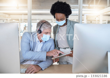 Covid, call center and coaching employees with mask at computer, help for senior man and black woman with tablet. Compliance, consulting and sharing opinion for medical advisory agency with diversity 133021186