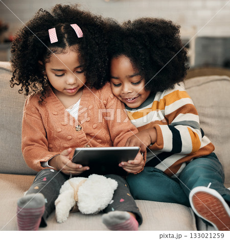 Happy children on sofa with tablet for online education, fun games and watch internet cartoon or video together. Biracial family kids on couch with digital technology, app or web for movie streaming Happy children on sofa with tablet for online education, fun games and watch internet cartoon or video together. Biracial family kids on couch with digital technology, app or web for movie streaming 133021259