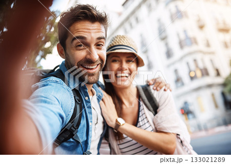 Tourist couple, happy and selfie for travel on a city street with a partner for holiday memory. Face of a man and woman outdoor on urban road for adventure, journey or vacation for freedom and relax Tourist couple, happy and selfie for travel on a city street with a partner for holiday memory. Face of a man and woman outdoor on urban road for adventure, journey or vacation for freedom and relax 133021289