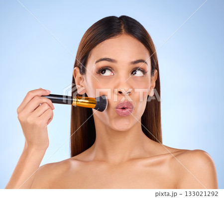 Beauty, makeup and brush with woman in studio for cosmetics, satisfaction and self care. Glow, foundation and blush with girl model on blue background for facial, powder and cosmetology product 133021292