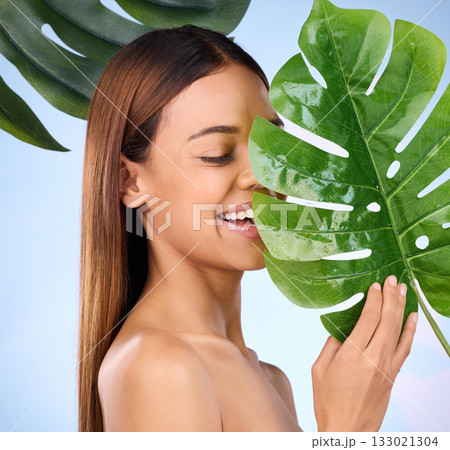 Woman, smile and leaf in natural beauty and organic skincare cosmetics for self love or care against a blue studio background. Happy female smiling and holding leafy green plant for healthy wellness Woman, smile and leaf in natural beauty and organic skincare cosmetics for self love or care against a blue studio background. Happy female smiling and holding leafy green plant for healthy wellness 133021304