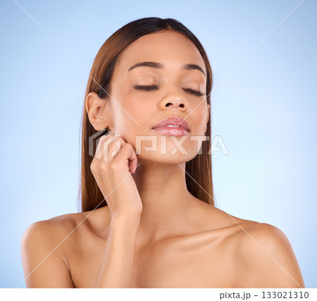 Skincare, self care and woman beauty with smooth clear skin after cosmetic treatment or facial isolated in a studio blue background. Soft, natural and clean model due to dermatology Skincare, self care and woman beauty with smooth clear skin after cosmetic treatment or facial isolated in a studio blue background. Soft, natural and clean model due to dermatology 133021310