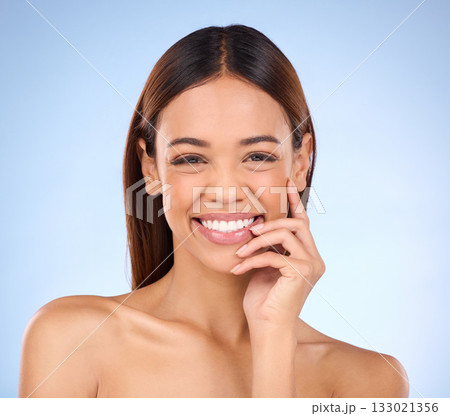 Beauty, portrait and woman with smile, dermatology and treatment against a blue studio background. Face, female and lady with joy, morning routine and skincare for grooming, clear and smooth skin 133021356