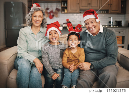 Portrait, christmas and grandparents on the sofa with their grandchildren in the living room as a family. Love, kids or celebration with a senior man, woman and kids together in their lounge Portrait, christmas and grandparents on the sofa with their grandchildren in the living room as a family. Love, kids or celebration with a senior man, woman and kids together in their lounge 133021376