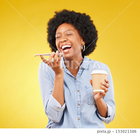 Phone, happy and black woman with coffee in studio, laughing with voice to text on yellow background. Smartphone, speaker and girl with tea on phone call, joke and humor while enjoying conversation 133021386