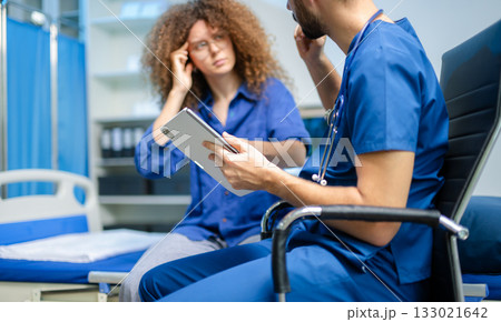 young woman consults a male doctor in a digital clinic. Medical diagnosis, concern, and professional care young woman consults a male doctor in a digital clinic. Medical diagnosis, concern, and professional care 133021642