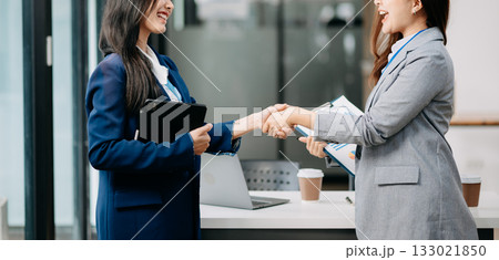 Two confident business man shaking hands during a meeting in the office, success, dealing, greeting and partner Two confident business man shaking hands during a meeting in the office, success, dealing, greeting and partner 133021850