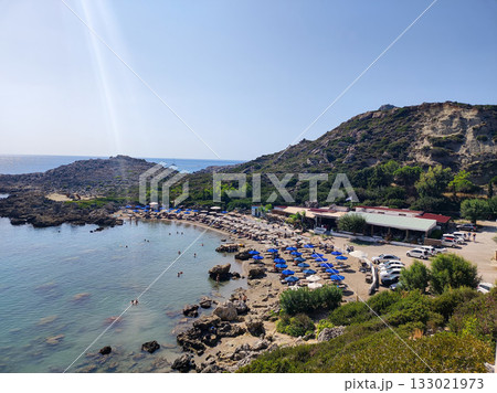 Discover a Beautiful Beach featuring Clear Waters, Comfortable Sun Beds, and Scenic Views 133021973