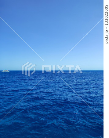 The serene view of the majestic ocean under a bright, clear blue sky is simply breathtaking The serene view of the majestic ocean under a bright, clear blue sky is simply breathtaking 133022005
