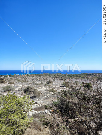 Stunning Scenic Coastal View Featuring a Clear Blue Sky Above the Calm Ocean Horizon Stunning Scenic Coastal View Featuring a Clear Blue Sky Above the Calm Ocean Horizon 133022007