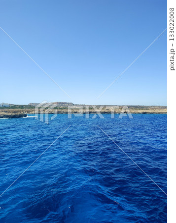 Stunning Blue Ocean Waves Gently Rolling Beneath a Clear and Beautiful Sky Above 133022008